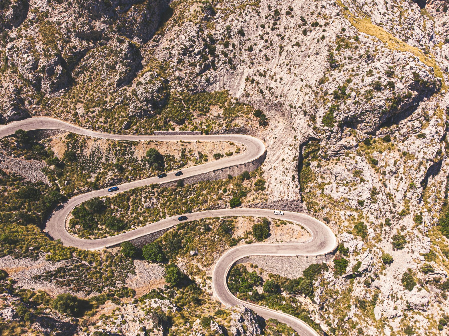 Aerial view of the Sa Calobra hairpin switchbacks descending through the mountains