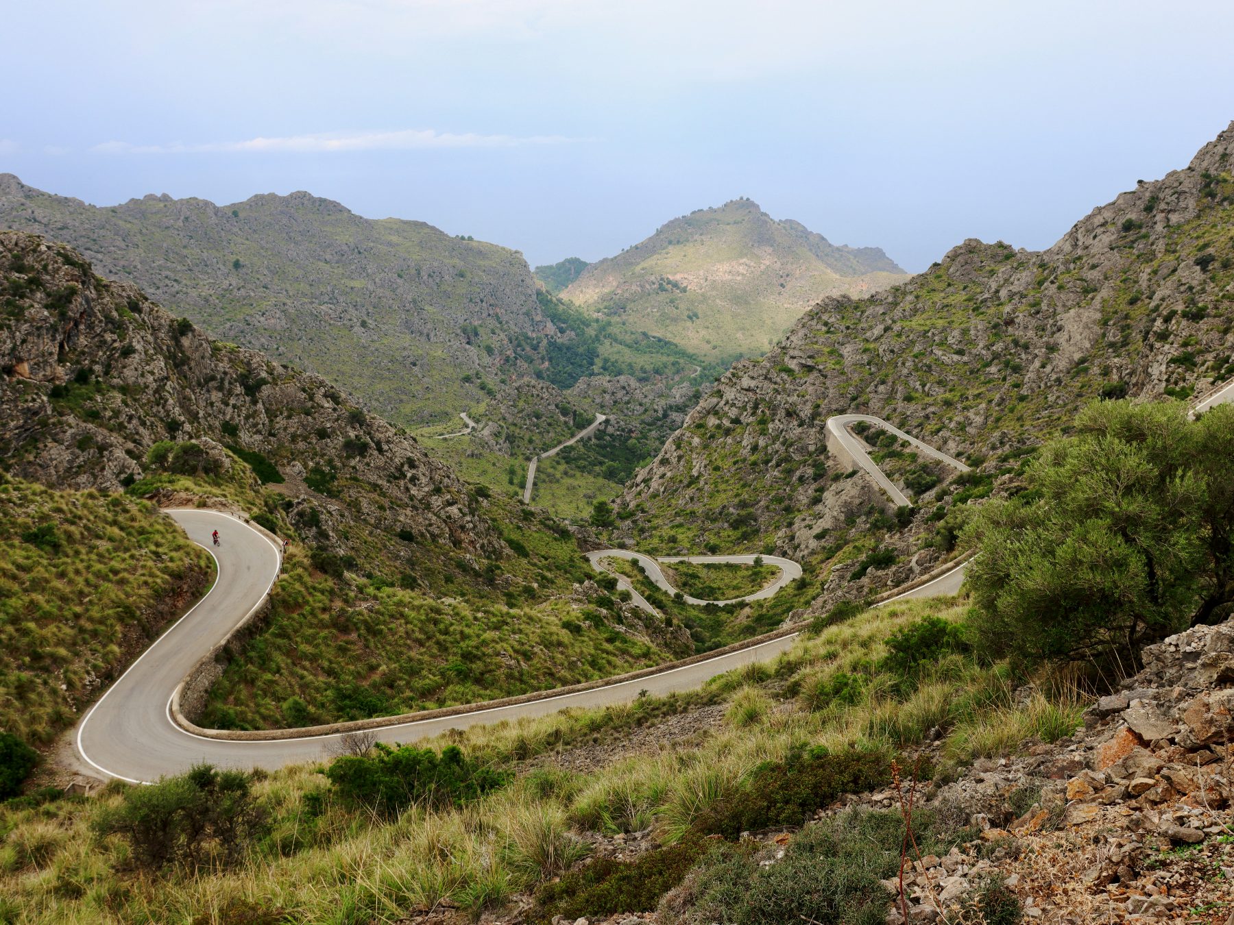 A road winding down through the Tramuntana valley toward the sea